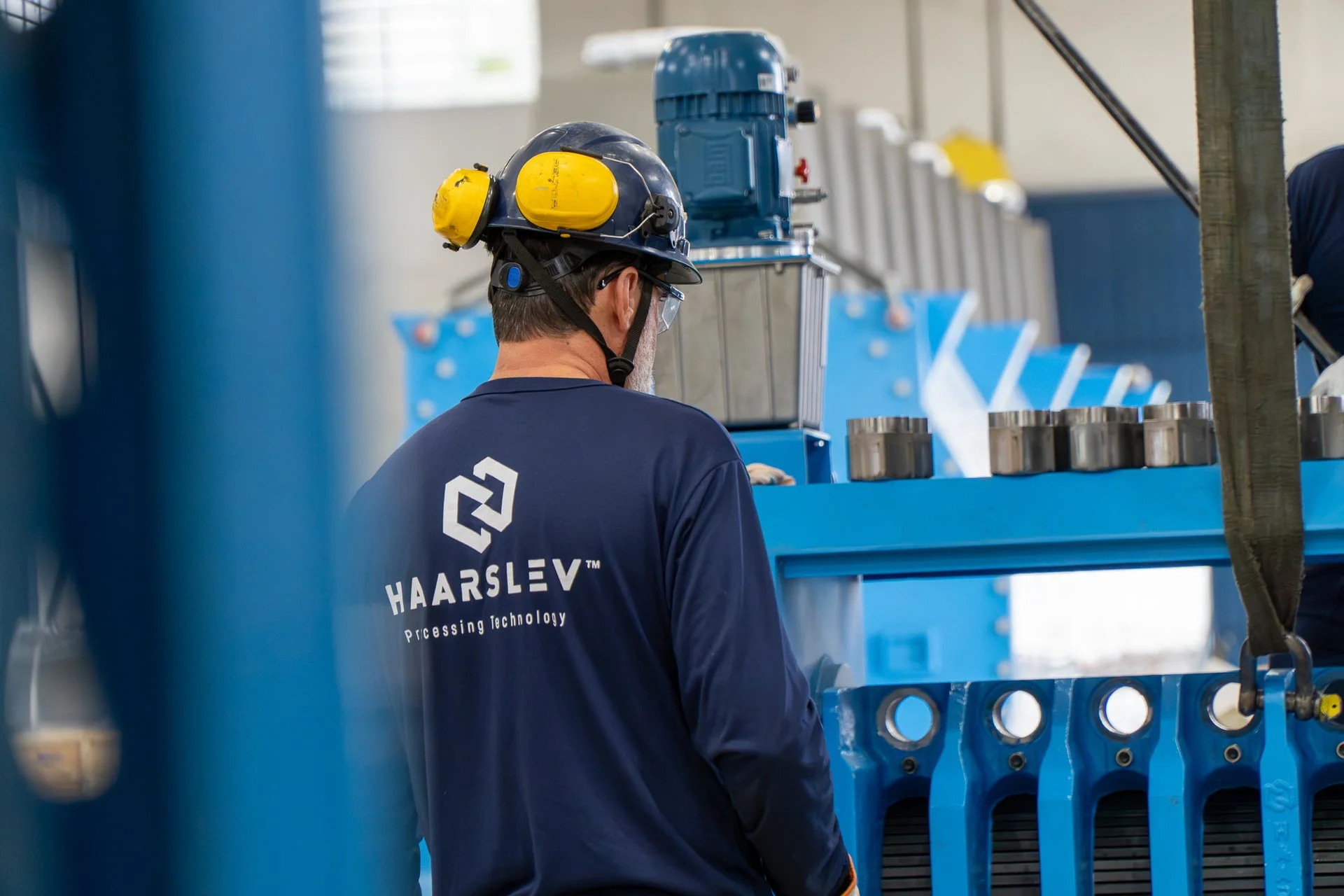 A Haarslev service specialist at work on a processing line